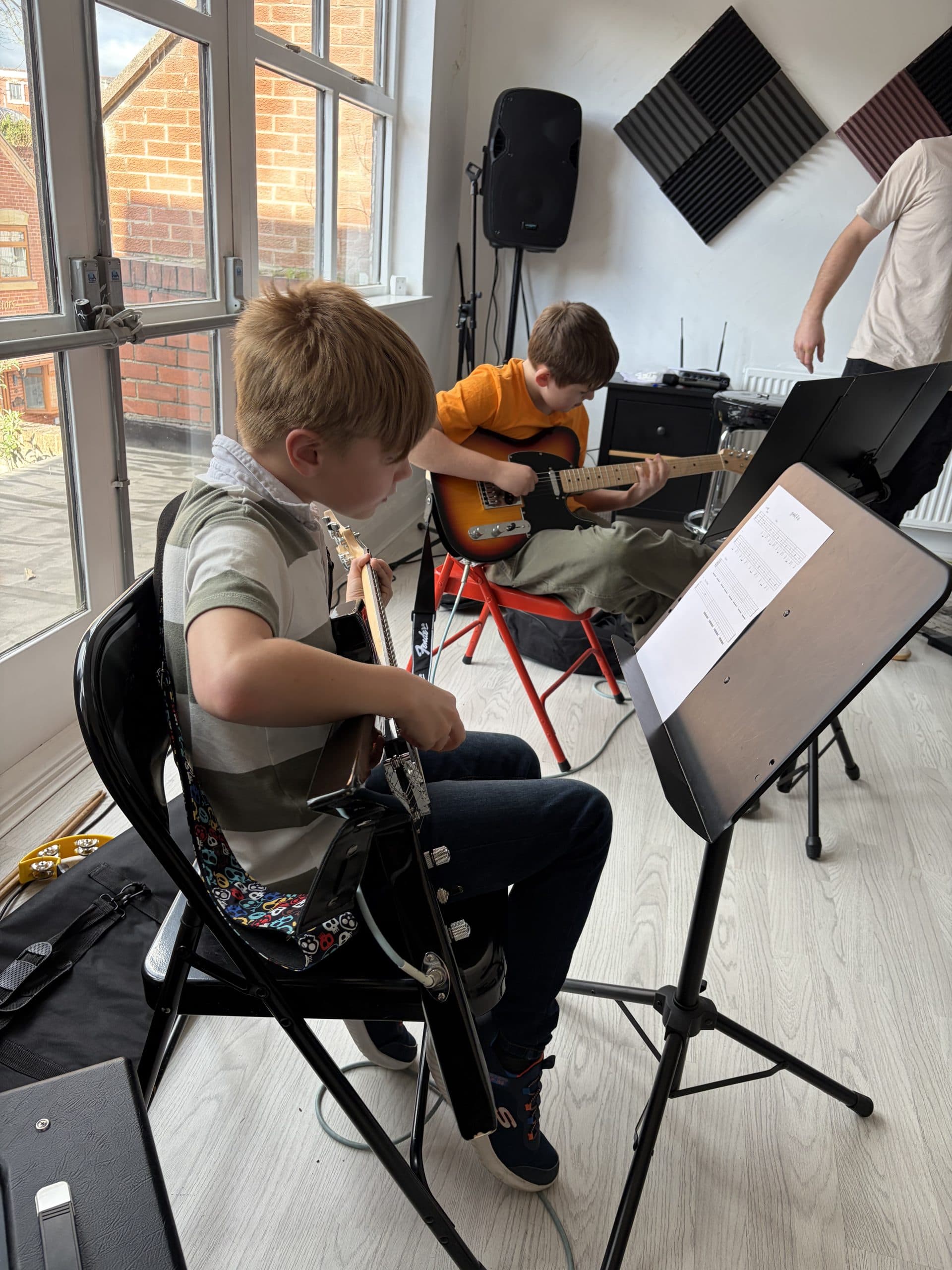 Young guitar students rehearsing together