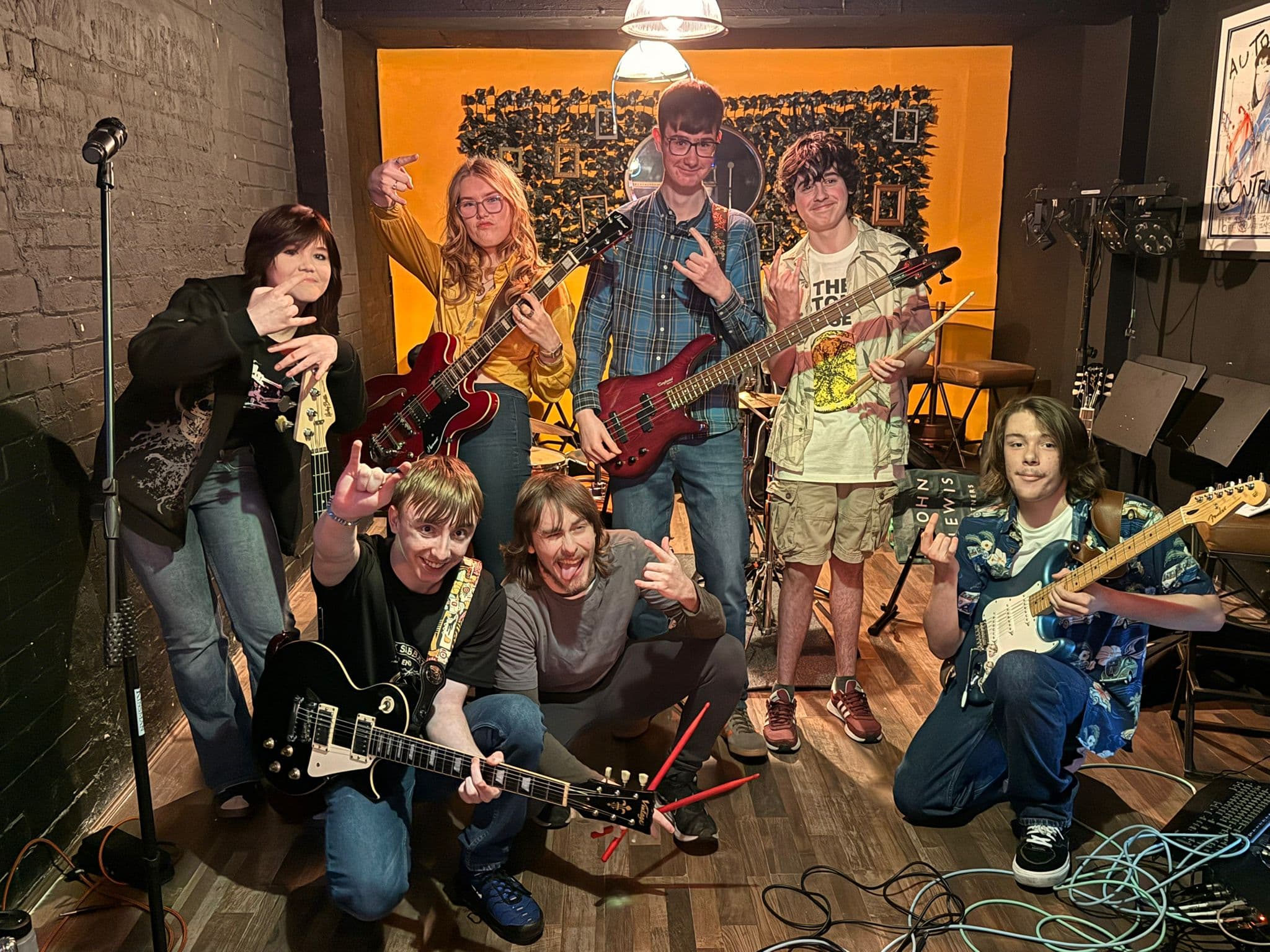 A group of young musicians celebrating after playing together