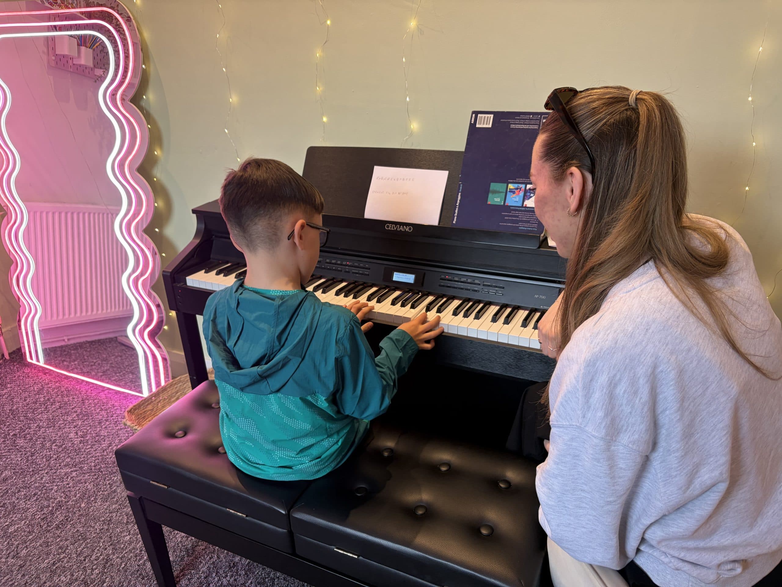 A young student playing piano during a lesson